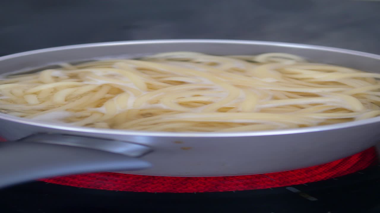 스파게티 가 스토브 에 있는 비 에서 조리 되고 있다