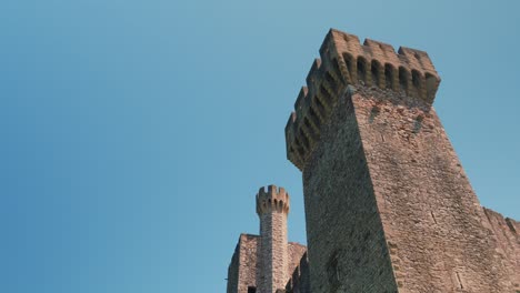 slow establishing shot of the beautiful towers at chateau de pouzilhac