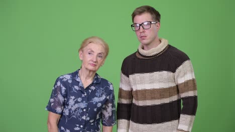 grandmother and grandson thinking while waiting together