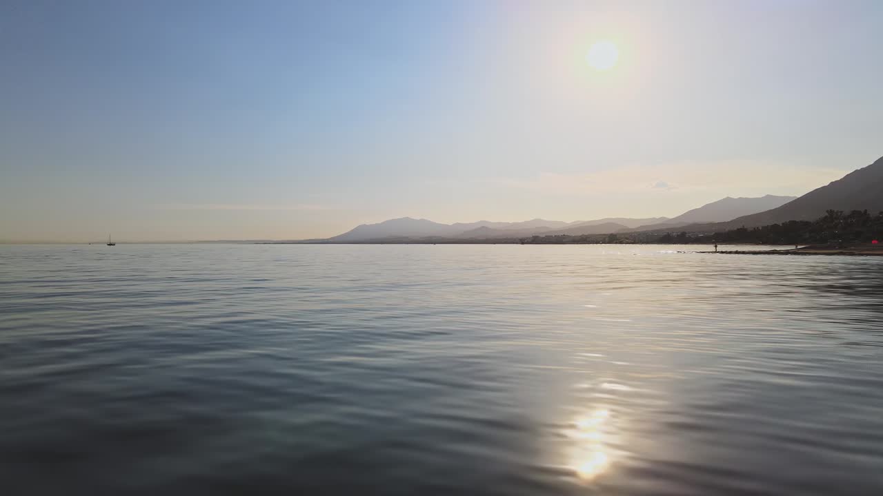 Fast panning left movement over the coastline into the ocean