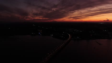 a bridge over which the sun sets and a panoramic view of the sea