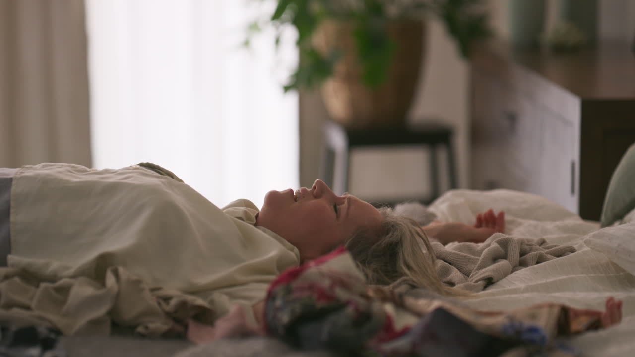 Woman relaxing on bed with clothes