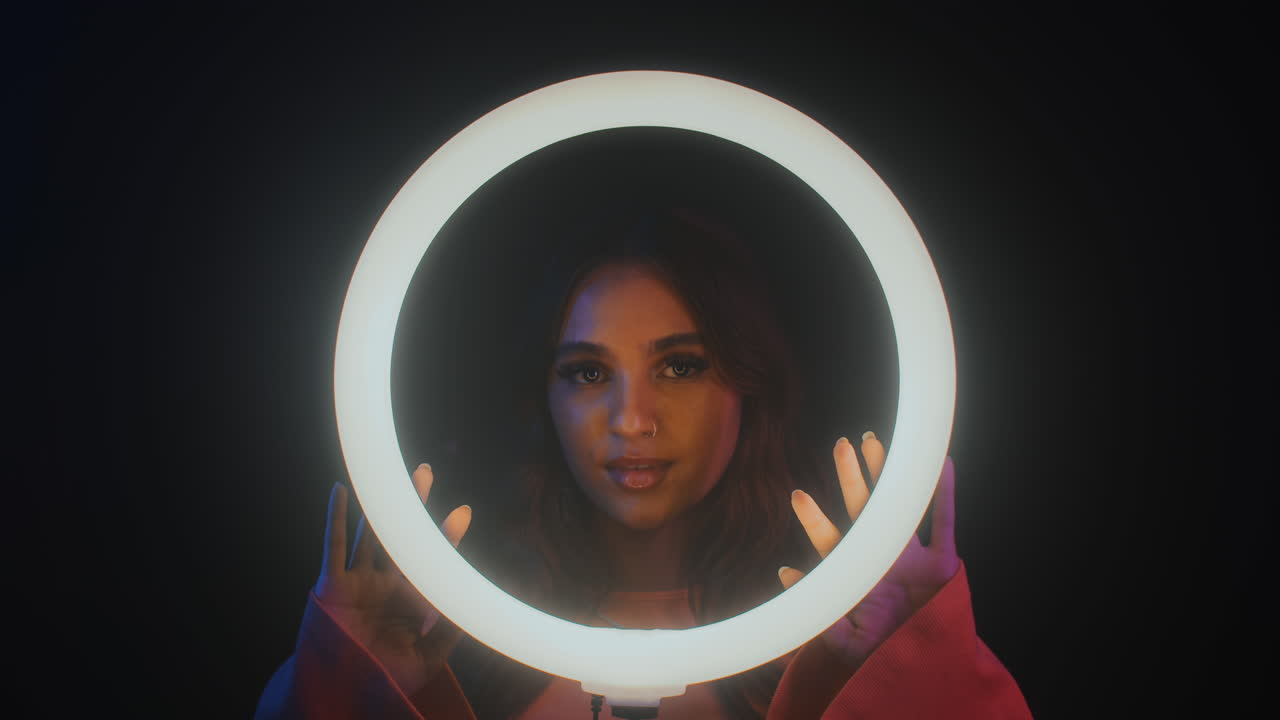 Young Asian Woman Standing behind Ring Light