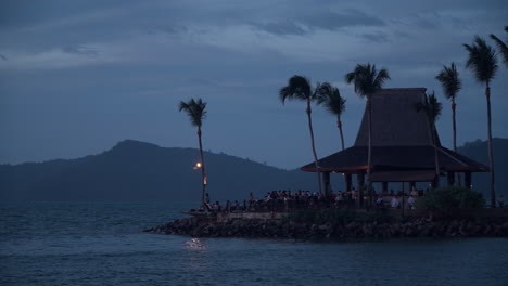 many trourist people enjoy sunset view at sunset bar at shangri-la resort tanjung aru beach in kota kinabalu