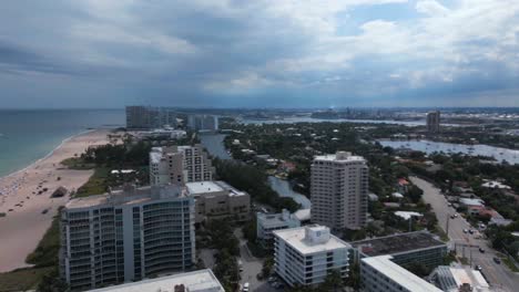 Aerial-drone-shot-of-hotel,-settlement-and-villa-beachside-resort-with-dark-sky