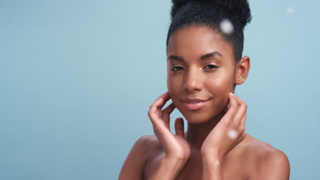 black woman, feathers and soft skincare model