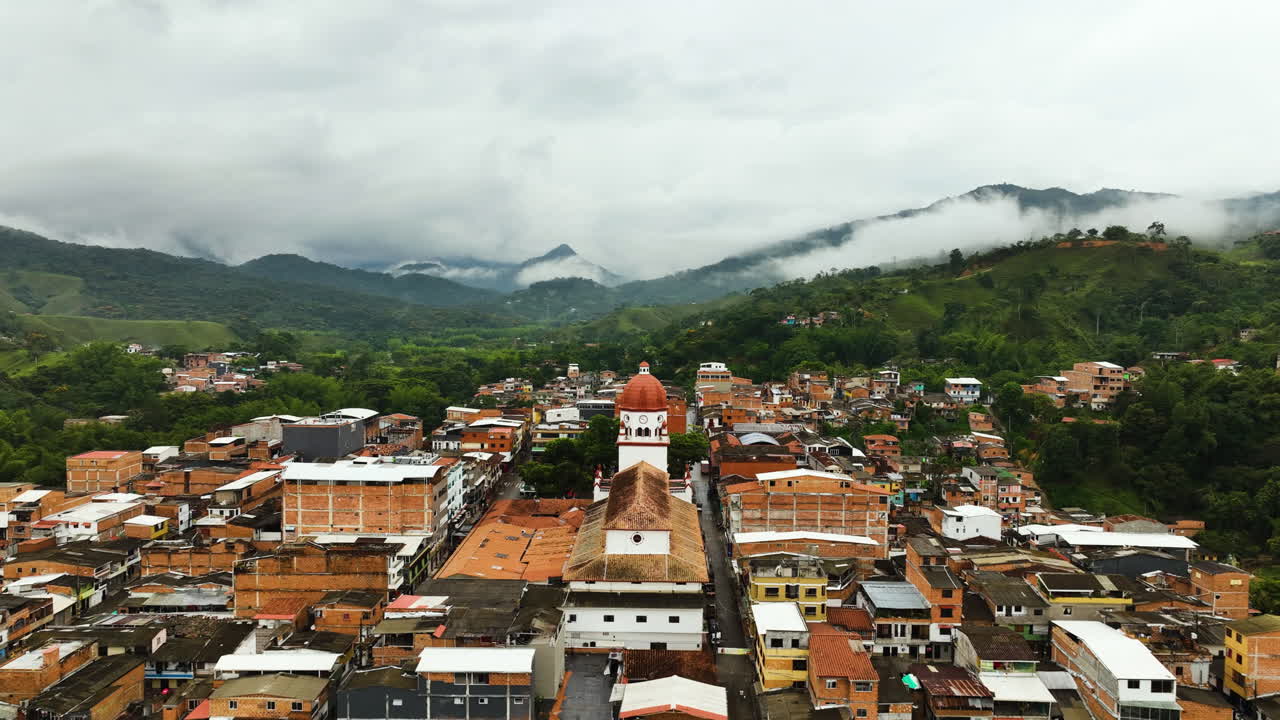 Aerial tilt shot behind the St Raphael's Church in cloudy San Rafael, Colombia