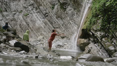 woman at waterfall in a mountain stream