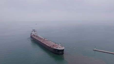 freighter loaded with gravel navigating away from kingsville seaport in canada