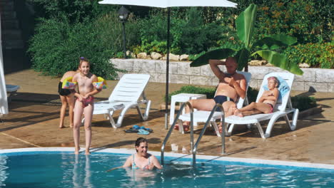 people sitting by the poolside of a resort swimming pool