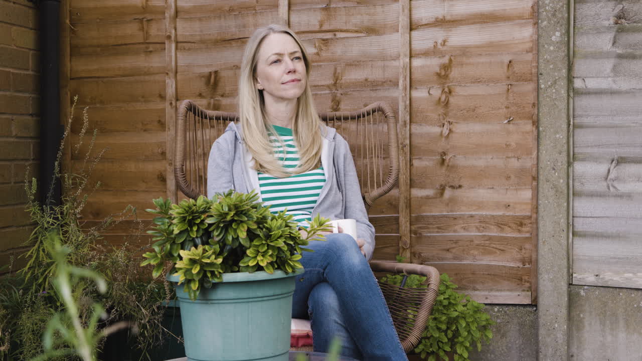 Woman relaxing in garden with coffee