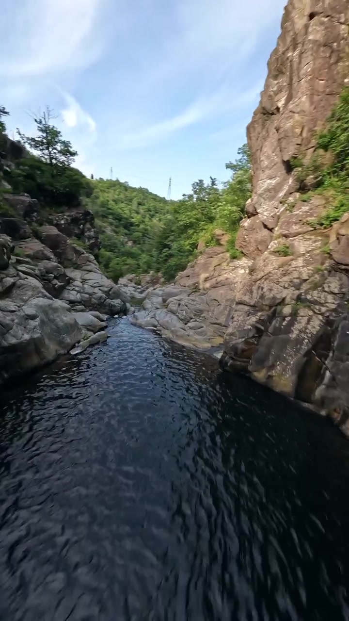 Una cascata si getta da una ripida scogliera in un paesaggio naturale aspro. La scena evoca un senso di potenza e bellezza selvaggia. Utile per documentari sulla natura o servizi di viaggio.