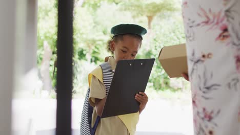 Animation-of-african-american-girl-in-scout-costume-delivering-package-to-biracial-woman