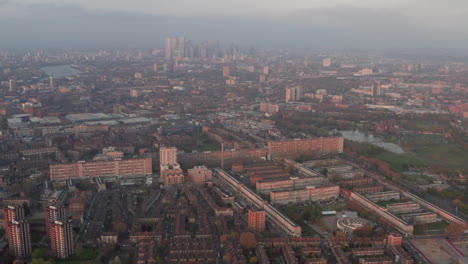 aerial slider shot over south london council estates looking towards canary wharf