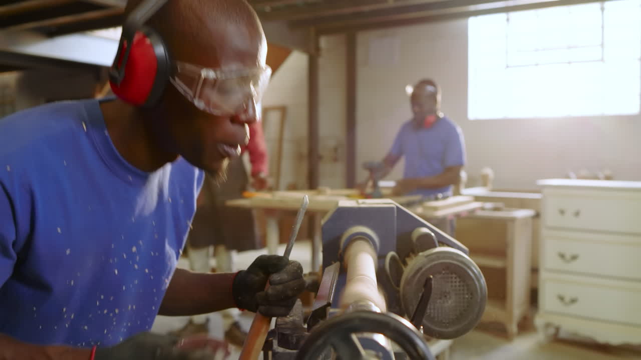 Securing chisel to lathe, mid adult Black carpenter shaving blank for shaping at shop, copy space
