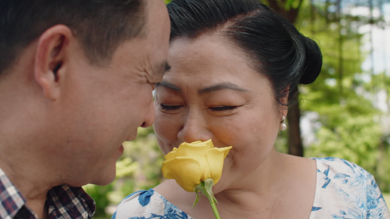 Mature Woman Rejoicing at Flower Given to Her as Present from Caring Husband