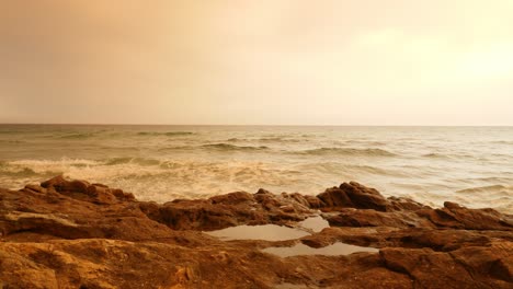 wildfires in the distance blocking out the sun and casting an orange haze