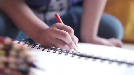 child drawing in a notebook