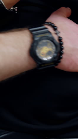 male hand with a black wristwatch strokes pregnant lady's belly. cropped image of a couple expecting a baby soon. close up.. vertical video