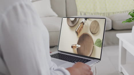 Biracial-woman-using-laptop-at-home-for-online-shopping,-slow-motion