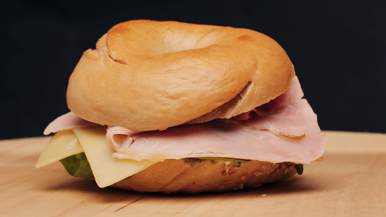 Bagel sandwich brunch, lunch plate of a bagel with smoked salmon and cream cheese and ham, close up morning cafe menu.