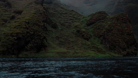 Skoga-River-flowing-from-Skogafoss-waterfall-in-Iceland-on-a-dark,-cloudy-morning