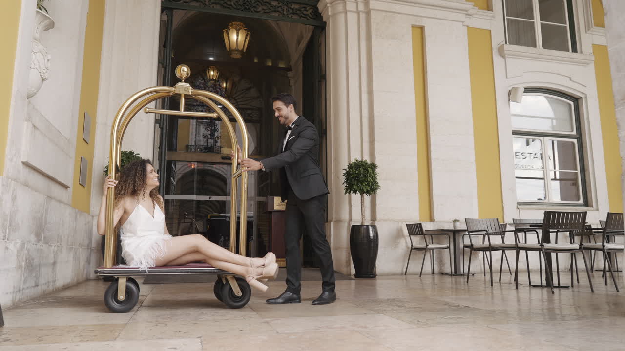 Couple having fun at a hotel entrance
