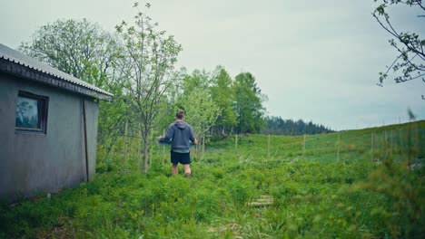 man carrying metal wire mesh for building fence