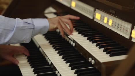 close-up of hands playing on a viscount organ keyboard