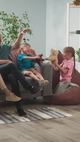 mom and dad play toys together with children, express joy, laugh, family weekend, home comfort, holidays