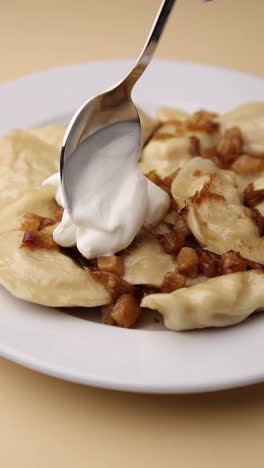 pierogi with sour cream and onions