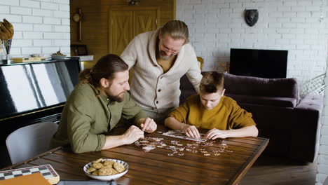 caucasian men and boy in the living room