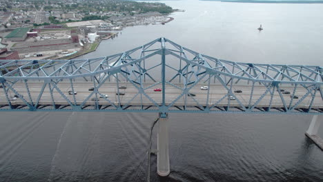 Aerial-orbit-view-of-Braga-Bridge-and-Battleship-Cove-in-Fall-River,-MA