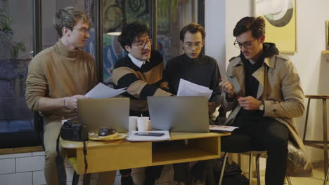 businessmen reading documents in cafe