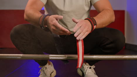 sportswoman preparing to lift barbell