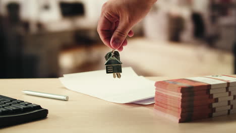 house keys, contract, and money on the table