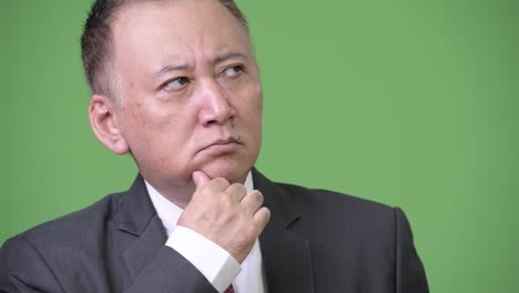 mature japanese businessman thinking