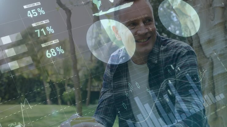 Data analytics and graphs animation over man sitting outdoors in park