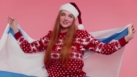 Adult-girl-patriot-in-Christmas-sweater-waving-and-wrapping-in-Israel-national-flag,-celebrating