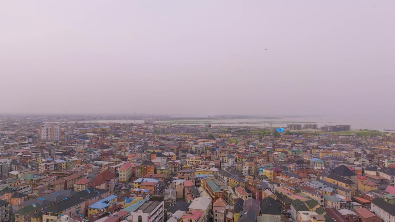 "Experience Lagos like never before with breathtaking aerial views of its iconic high-rise buildings towering over the bustling cityscape, captured beautifully at sunset