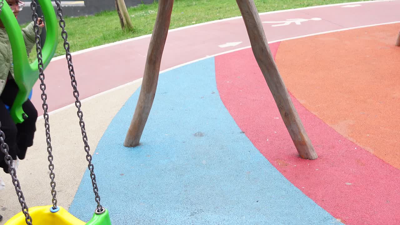 Girl on a Swing at a Colorful Playground
