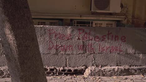 political inscription on old stone wall in residential district