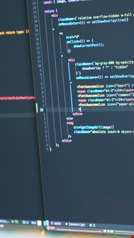 close-up of coding on dual screens featuring javascript. bright, focused lighting enhances the text details. perfect for vertical video in mobile and social media