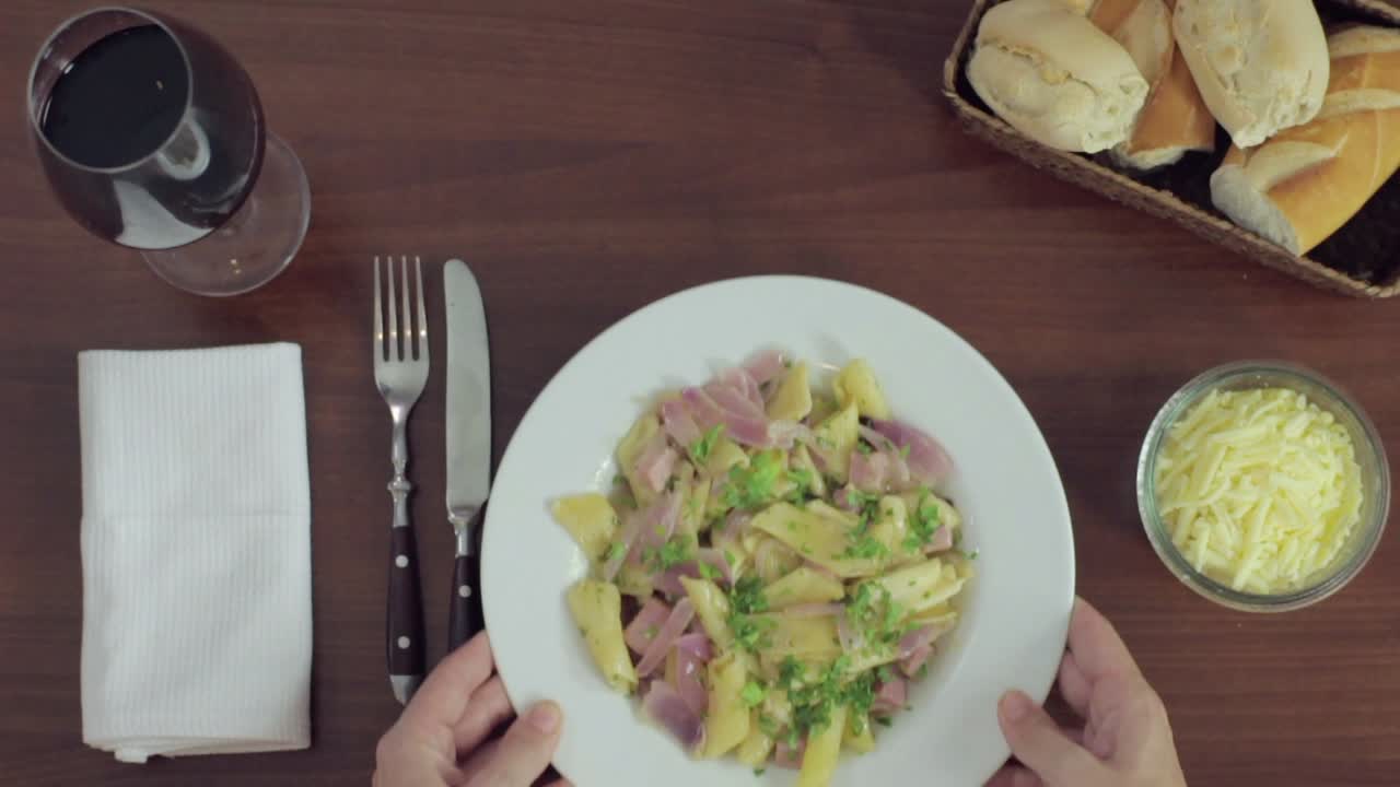 Delicious Pasta Meal with Wine and Bread on a Wooden Table