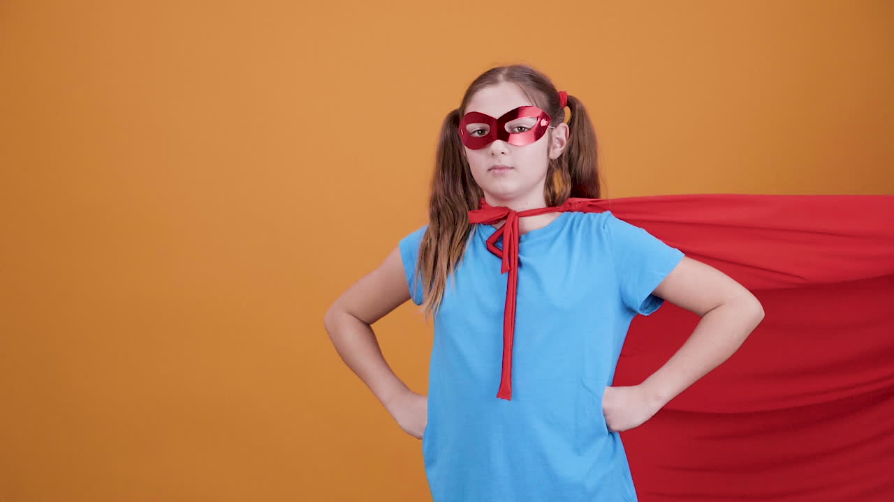 Girl in Superhero Costume with Red Cape and Mask