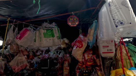 colorful market stall with various hanging items