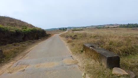 motorcycle-rider-ridding-bike-at-remote-tarmac-at-day-from-flat-angle