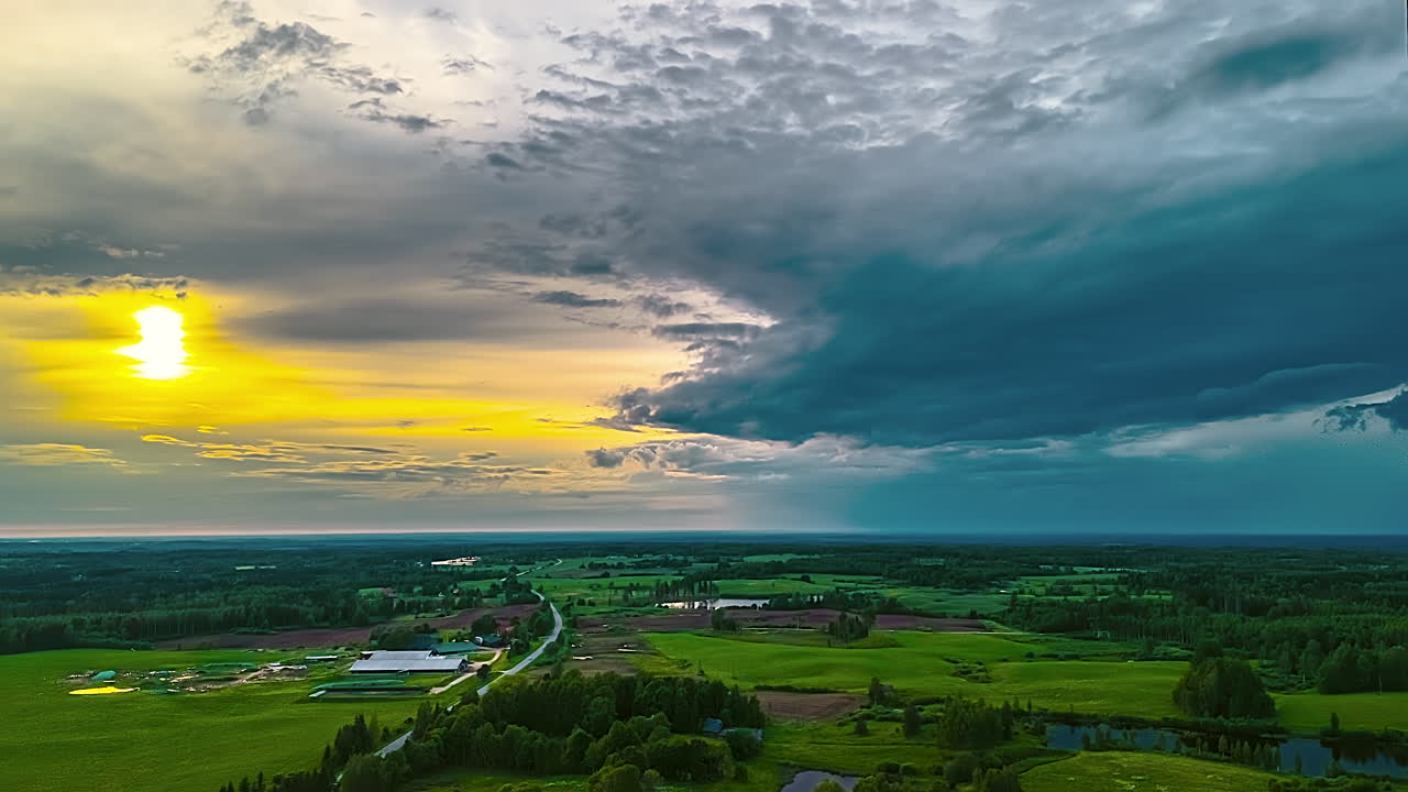 Time-lapse of vibrant sunset over lush green fields, evokes tranquility