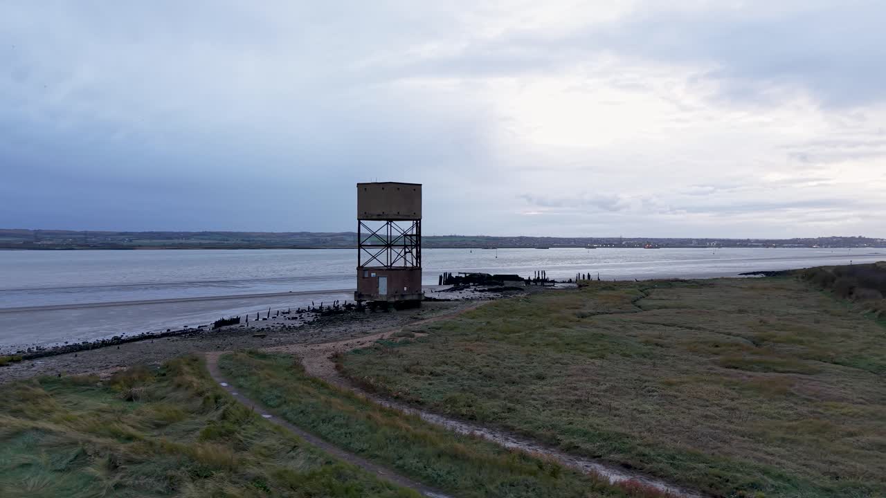 East Tilbury radar tower aerial view low angle circling the River Thames marshland landmark