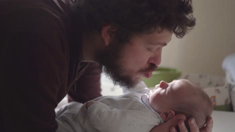 father interacting with newborn baby at home